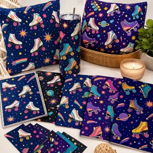 May include: A selection of roller skate-themed products on a white surface. The items include cushions, notebooks, fabric samples, and a tumbler. The items feature a navy blue background with colourful roller skates, stars, and planets.