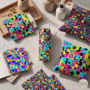 May include: A collection of items with a retro pixel design. Includes a tumbler, two throw pillows, a notebook, a folded cloth, and two coasters. The items feature a colorful pixelated pattern in shades of blue, green, yellow, pink, and black.