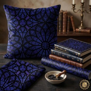 May include: A decorative pillow, a folded cloth, and a roll of paper feature a stained-glass window design in shades of blue and black. The design is also on the covers of several books. A small bowl holds wax seals and a stamp. A premium collection logo is visible.