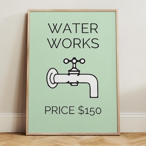 May include: A framed print with a light green background and the words "WATER WORKS" in black. Below is a black and white illustration of a water faucet. The text "PRICE $150" is at the bottom. The frame is a light brown color.