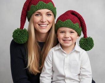 May include: Two red and green crochet elf hats with long, pointed tops and green pom-poms. One hat is worn by an adult, the other by a child. The hats have a green scalloped trim.