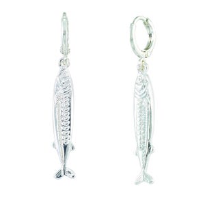May include: A pair of silver-colored fish-shaped earrings. Each earring features a detailed fish design with scales and fins, suspended from a hinged hoop closure. The earrings are displayed against a white background.