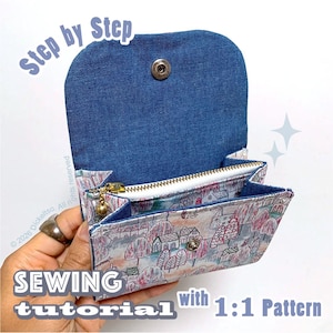 May include: A small fabric pouch with a denim flap and a metal snap closure. The exterior features a colorful illustrated pattern of houses and trees. The interior includes a zippered compartment with a gold-toned pull. Text reads Step by Step SEWING tutorial with 1:1 Pattern.