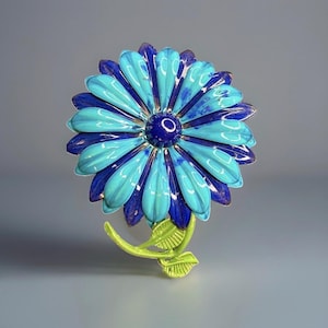 May include: A flower-shaped brooch featuring layered petals in alternating shades of bright turquoise and deep royal blue. The center is a dark blue circular disc. A light green stem with two textured leaves extends from the bottom of the flower.