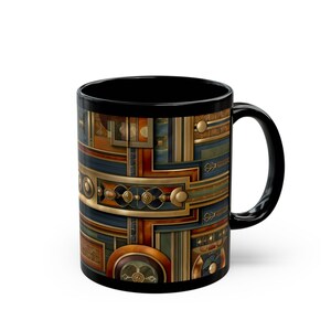 May include: Black ceramic coffee mug with a detailed Art Deco design in shades of gold, blue, brown, and copper. The mug features geometric patterns and shapes, with a black handle and interior. A stylish and decorative drinkware item.
