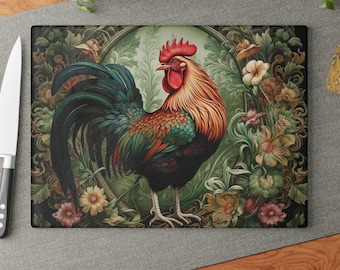 May include: A rectangular glass cutting board featuring a central illustration of a rooster with red, orange, and dark green plumage. The rooster is framed by an oval border surrounded by detailed botanical patterns of various flowers and leaves.