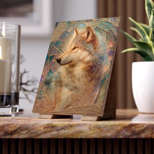 May include: A rectangular tabletop plaque featuring a detailed illustration of a wolf in profile. The wolf is set against a background of golden, geometric, stained-glass-style patterns with soft blue and purple accents, supported by a wooden stand.