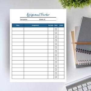 May include: A white assignment tracker with a blue header that reads "Assignment Tracker." The tracker includes sections for class, assignment, due date, done, and grade. A keyboard, notebooks, and a pen are visible in the background.