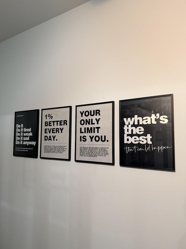 May include: Four framed motivational posters with black frames and white text. The posters display phrases like "Do it anyway," "1% better every day," and "Your only limit is you." The last poster says "what's the best that could happen."