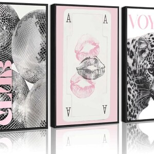May include: A set of three framed wall art prints. The first features silver disco balls with the pink text LUXURY CLUB. The second shows a pink playing card with lip prints. The third displays a leopard with the pink text VOYAGE at the top.