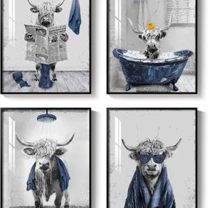 May include: A set of four framed wall art prints featuring a Highland cow in various bathroom scenes. One cow reads a newspaper, one sits in a blue bathtub with a yellow rubber duck, one stands under a shower, and one wears sunglasses and a blue towel.