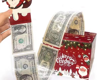 May include: A Christmas-themed gift box with a red and white design, featuring Santa Claus and the text "Merry Christmas." The box dispenses dollar bills when pulled, with a Santa Claus cutout on top.