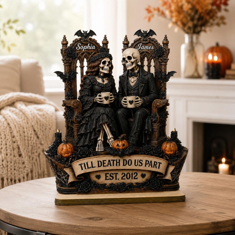 May include: A decorative figurine featuring two skeletons dressed in black wedding attire, seated on ornate thrones. The base displays the text "TILL DEATH DO US PART" and "EST. 2012". The names "Sophia" and "James" are inscribed above each skeleton.