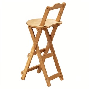 May include: A light brown bamboo folding stool featuring a circular seat, a curved backrest with horizontal slats, and a cross-legged frame design. The structure includes a footrest bar and visible metal hardware connecting the wooden components.