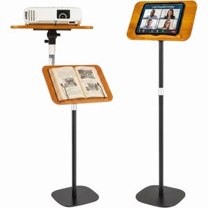 May include: Two adjustable floor stands with black metal bases and poles. One stand holds a white projector on a top shelf and an open book on a lower wooden tray. The second stand features a wooden tray holding a tablet displaying a live presentation.