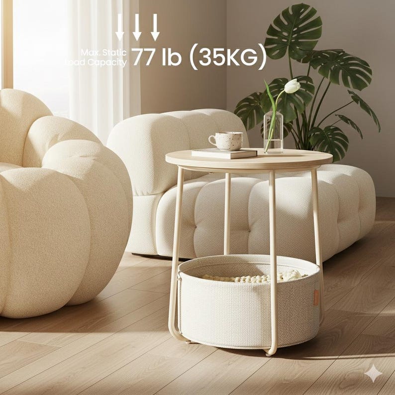 May include: A round, light wood side table with a cream-colored metal frame and a woven basket base. The table has a maximum static load capacity of 77 lb. A cream-colored sofa and a potted plant are in the background.