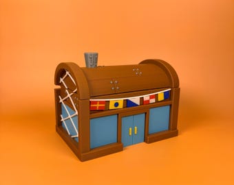 May include: A brown and blue building with a chimney and flags. The building has blue windows and doors with yellow handles. The roof is brown with metal accents. The building is on an orange background.