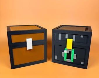 May include: Two pixelated treasure chests. One chest is brown with a black frame and a white latch. The other chest is black with a yellow latch and green and grey accents. The chests are on an orange background.