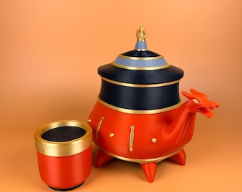 May include: A red and black incense burner with a dragon head design. The burner has gold accents and a matching red cup with a gold rim. The burner is set against a light orange background.