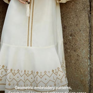 May include: Off-white dress with geometric gold embroidery. The dress features a tiered skirt and long sleeves. The text on the image reads: "Geometric embroidery patterns, Enrich visual layers and enhance design sense."