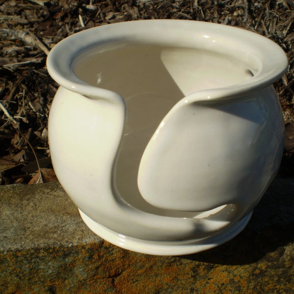 White glazed yarn bowl with 4 holes.