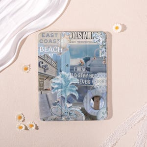 May include: A rectangular tablet case featuring a blue-toned coastal collage. The design includes a palm tree, a bicycle, a life preserver, a surfboard, and text reading EAST COAST, COASTAL LIFE, BEACH, and I WISH I COULD STAY HERE FOREVER.