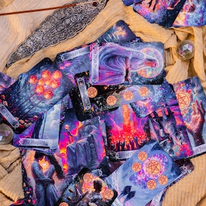May include: A collection of tarot cards with vibrant illustrations, featuring images of figures, celestial bodies, and symbols. The cards are arranged on a textured, golden-colored surface, with an incense holder and crystals.