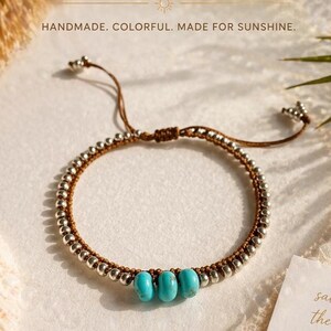 May include: Handmade bracelet featuring silver beads and three turquoise beads. The bracelet has a brown cord and is adjustable. The text in the image reads: HANDMADE. COLORFUL. MADE FOR SUNSHINE.