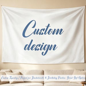 May include: A rectangular white wall tapestry featuring the text Custom design in a blue cursive script font. The fabric is smooth and hangs horizontally against a flat surface, displaying the dark blue lettering clearly in the center.