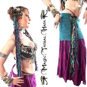 May include: A woman wearing a black and gold bra top with a purple skirt and a long, colorful beaded hairpiece. She is also wearing several bracelets on both arms. The image includes the text "Magic Tribal Hair".