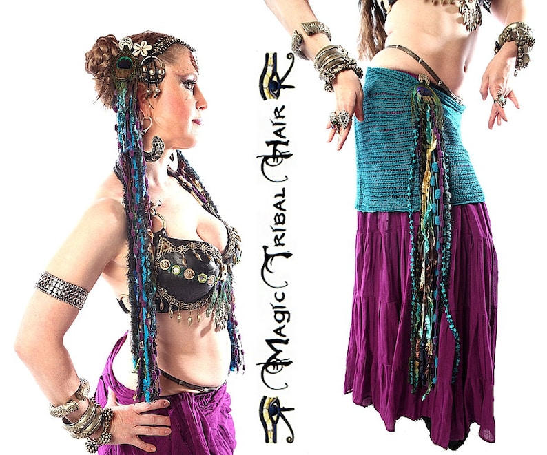 May include: A woman wearing a black and gold bra top with a purple skirt and a long, colorful beaded hairpiece. She is also wearing several bracelets on both arms. The image includes the text "Magic Tribal Hair".