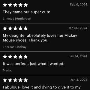 May include: A black screen displays customer reviews with star ratings and dates. Text includes phrases like "They came out super cute," "My daughter absolutely loves her Mickey Mouse shoes," and "It was perfect."