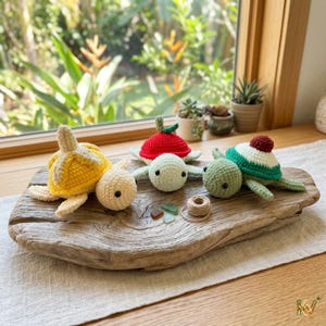 May include: Four handmade crochet turtle figurines in yellow, light green, red, and dark green, each with unique shell designs. They are displayed on a rustic wooden board with a neutral background, showcasing the handcrafted details.