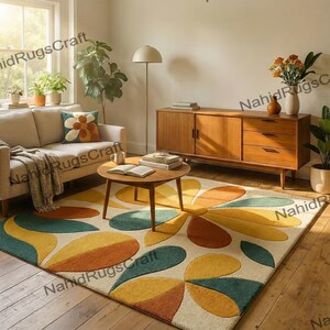 May include: A living room scene featuring a beige sofa, wooden coffee table, and a mid-century modern style wooden cabinet. A large area rug with a floral design in yellow, orange, and teal covers the floor. A decorative pillow with a flower design rests on the sofa.