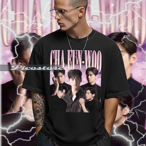 May include: Black crew neck t-shirt with a graphic of a group of men and the text "CHA EUN-WOO". The design has a vintage aesthetic, set against a pink and white background with lightning bolt graphics.