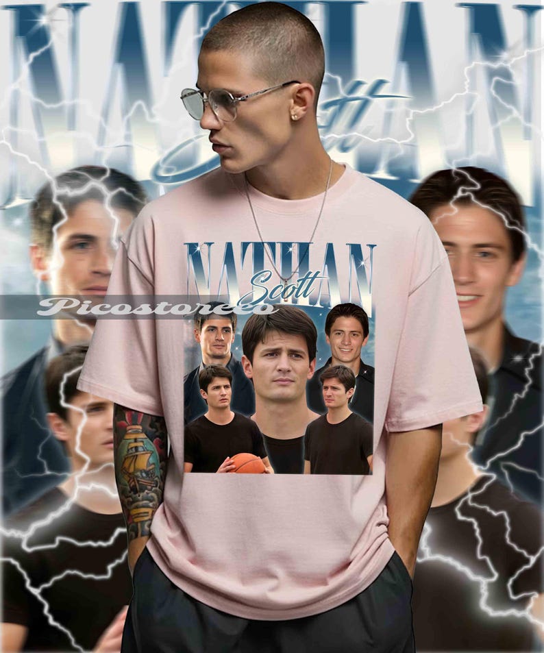 May include: A light pink t-shirt featuring the name "Nathan Scott" in a blue and white design. The shirt has multiple images of a person. The background has a lightning bolt design.
