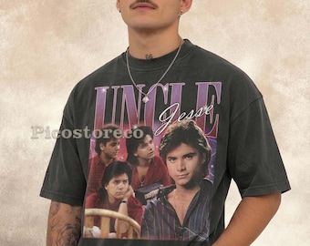 May include: A charcoal gray short-sleeve t-shirt featuring a graphic print of Uncle Jesse from Full House. The design includes the text "UNCLE" in large purple letters and "Jesse" in white script, along with three photographic images of the character.