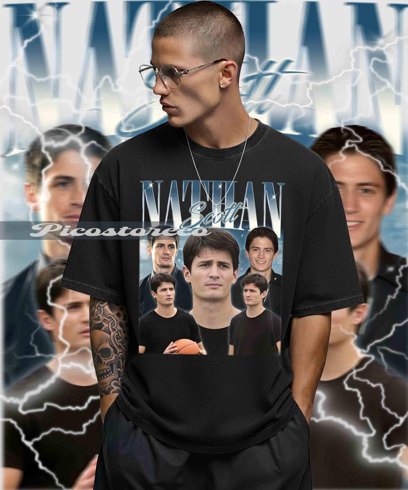 May include: Black t-shirt featuring a collage of images and the name "Nathan Scott" in a stylized font. The design includes multiple images of a person, with a basketball in one image. The background has a blue and white lightning design.