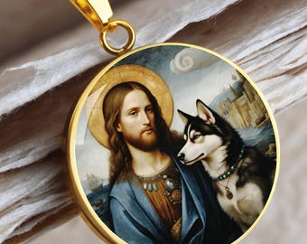 May include: Gold-toned pendant necklace featuring a round charm with a portrait of Jesus and a husky dog. The charm has a gold border and is suspended from a gold chain. The image depicts Jesus with a halo and a blue robe.