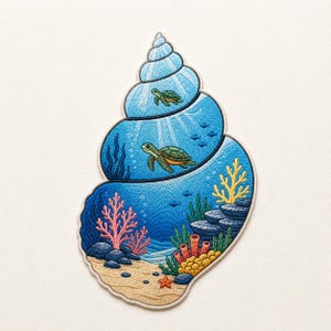 Könnte beinhalten: Gestickter Aufnäher in Form einer Muschel, mit einer Unterwasserszene. Zwei Meeresschildkröten schwimmen im blauen Wasser, umgeben von Korallen, Fischen und Pflanzen. Der Aufnäher hat einen cremefarbenen Rand.