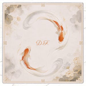 May include: A square decorative art piece featuring two koi fish in a circular design. The fish are orange and white, set against a cream-colored background with water and floral accents. The initials "D.F." are in the center.