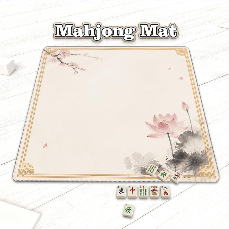 May include: A beige Mahjong mat with a gold border and floral design. The mat features a pink lotus flower and cherry blossoms. Several Mahjong tiles are placed on the mat, with the text "Mahjong Mat" at the top.