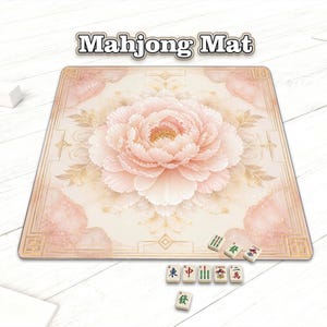 May include: A square mahjong mat with a large, light pink peony flower design in the center. The mat has a beige background with a decorative border and the words "Mahjong Mat" at the top. Several mahjong tiles are visible.