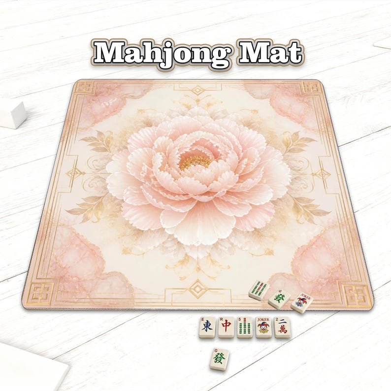 May include: A square mahjong mat with a large, light pink peony flower design in the center. The mat has a beige background with a decorative border and the words "Mahjong Mat" at the top. Several mahjong tiles are visible.