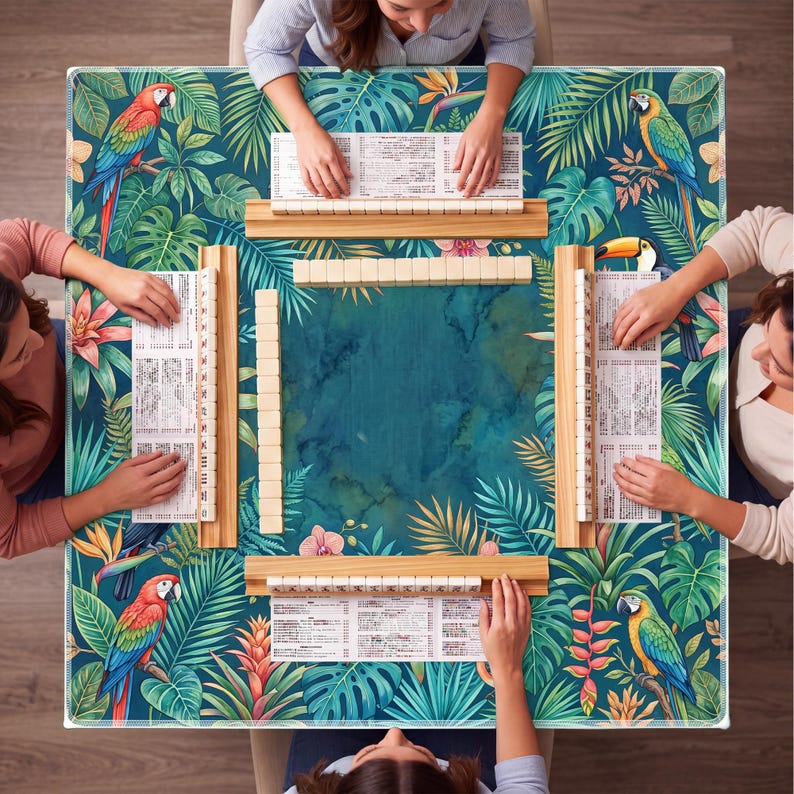 May include: A square Mahjong game table with a tropical design featuring parrots, toucans, and lush foliage. The table is surrounded by players, with wooden racks holding tiles and score sheets. The color palette includes teal, green, and pops of red and yellow.