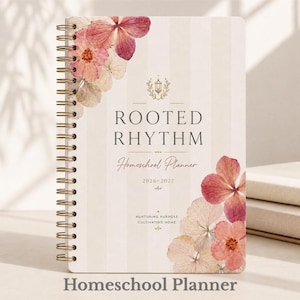 May include: A spiral-bound homeschool planner with a cream-colored cover featuring vertical stripes and floral accents. The cover text reads "ROOTED RHYTHM Homeschool Planner 2026-2027." Additional text includes "Nurturing Purpose, Cultivating Home."