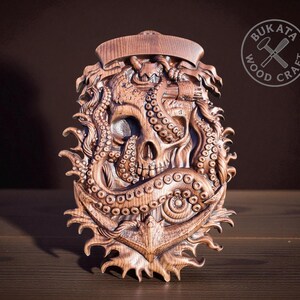 a wooden sculpture of a skull with tentacles, which appears to be a carved piece of art.