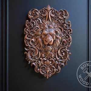 a highly detailed and ornate wooden carving of a lion's head, mounted on a dark background.