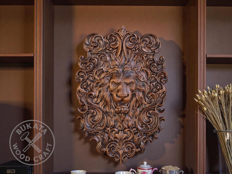 a large, intricately carved wooden lion head mounted on a wall, surrounded by various decorative elements such as a vase of flowers and a book.