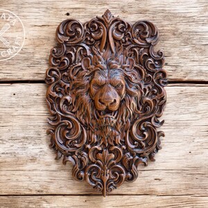 a detailed, intricately carved wooden lion head with a fierce expression, set against a wooden background.